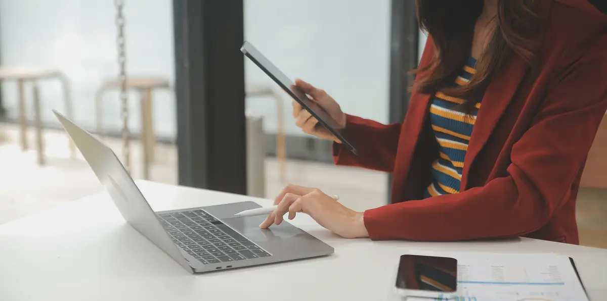 Portrait of a happy Asian businesswoman using mobile phone indoor Asian businesswoman working in modern office