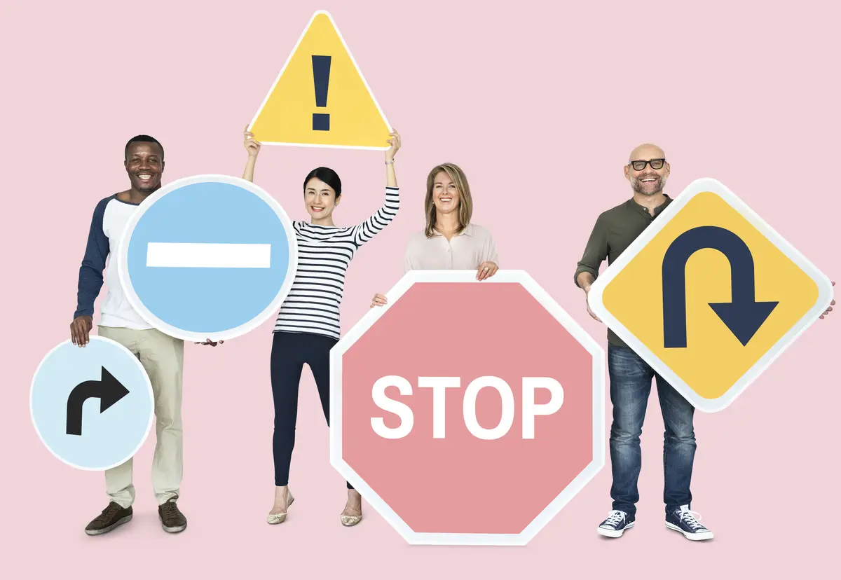 Happy diverse people holding road signs