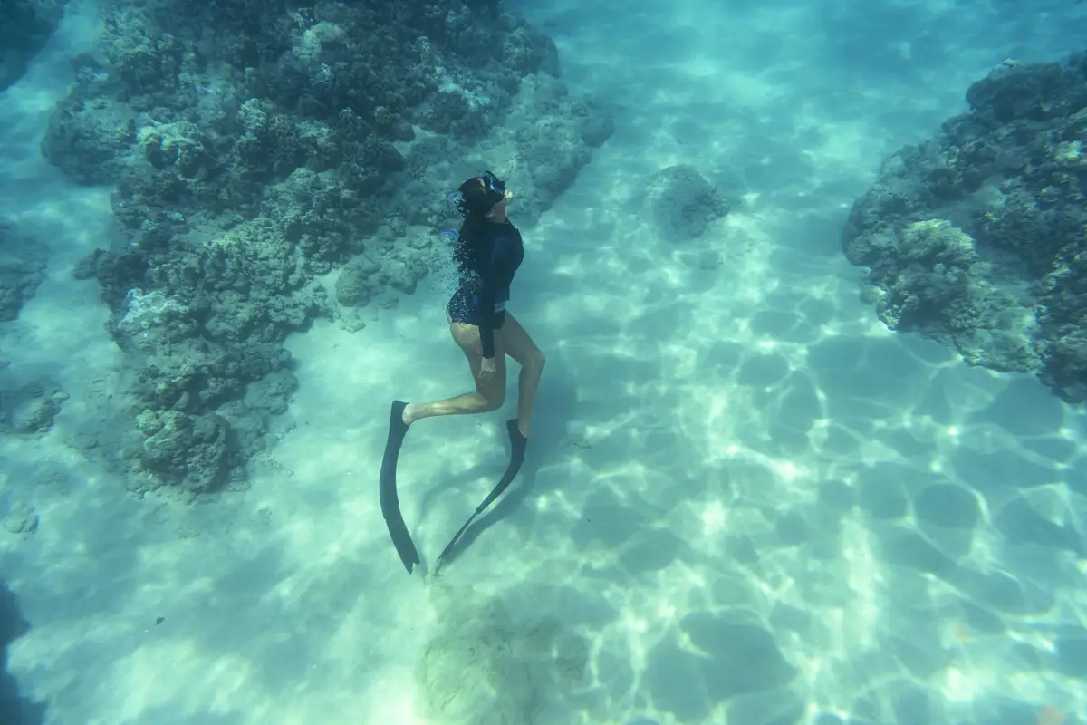 Woman freediving with flippers underwater