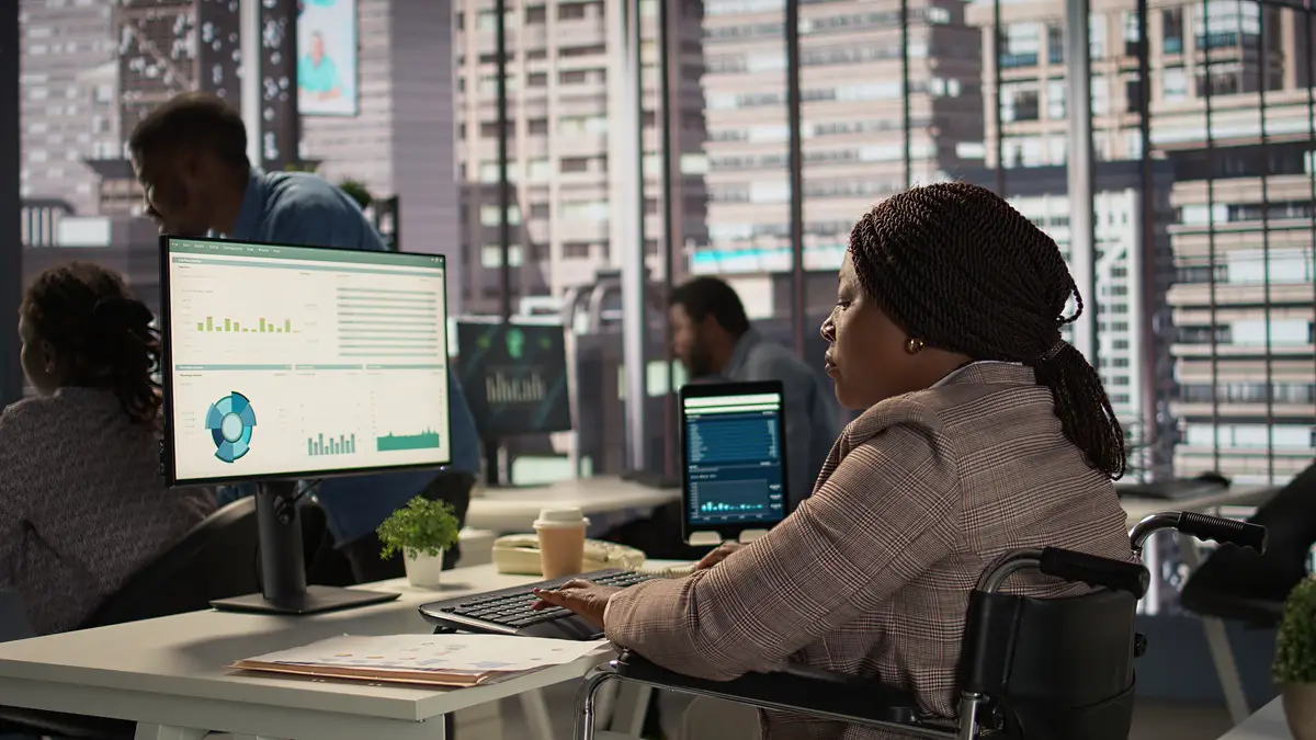 Female boss with chronic disability examining archived files and data reports