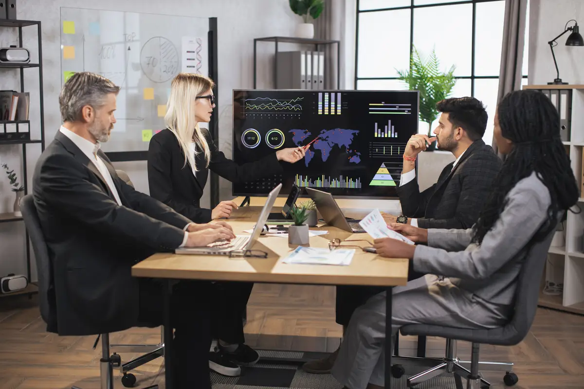 Pretty concentrated female boss leader at a meeting together with her diverse multiracial colleagues