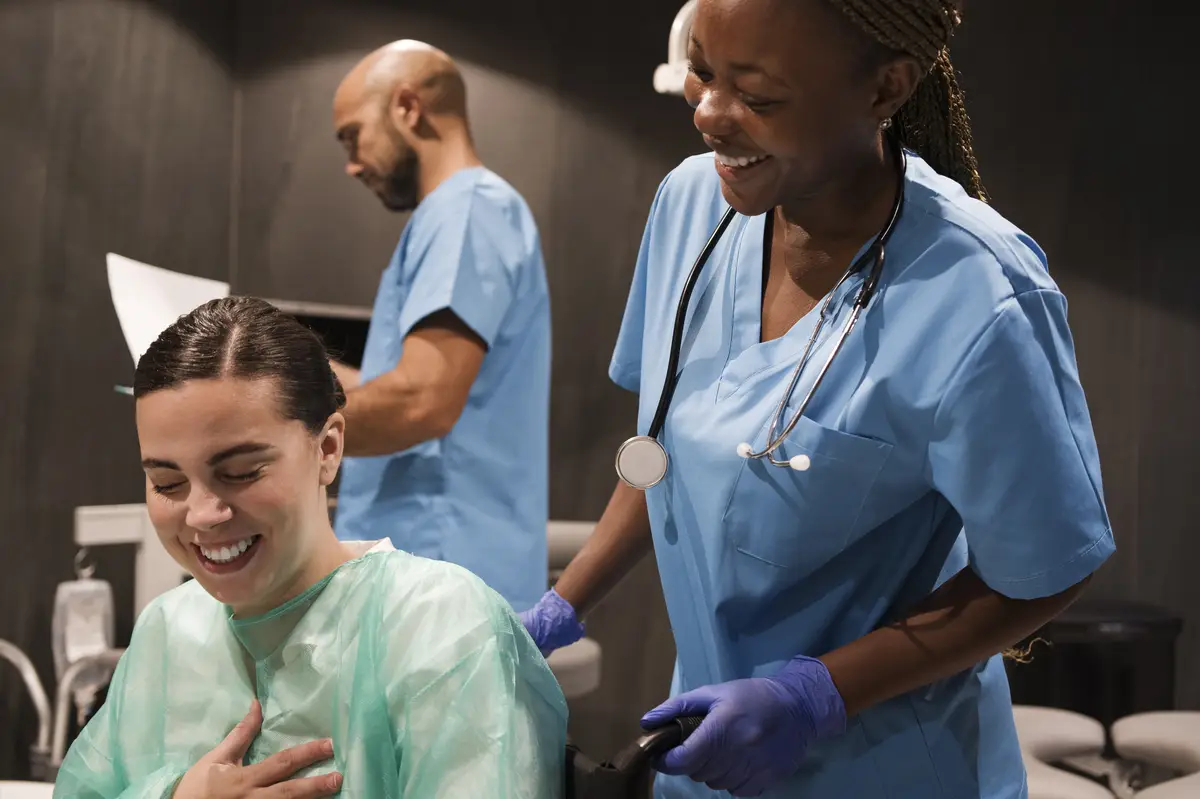 Nurse during her work at the clinic wearing scrubs and gloves