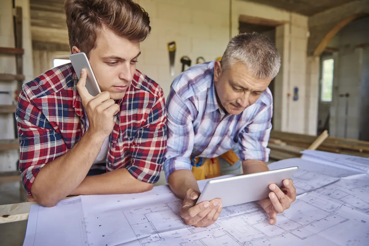 Collaboration of two carpenters in building