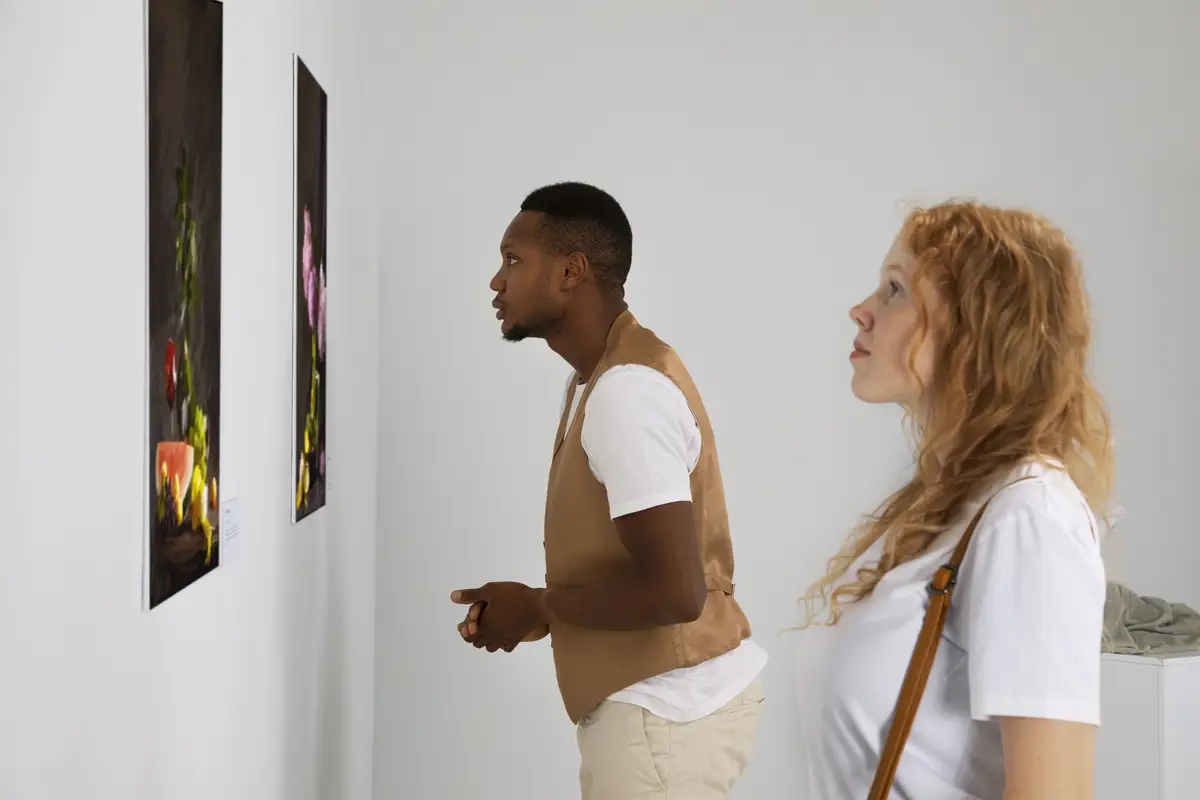 Side view people looking at painting