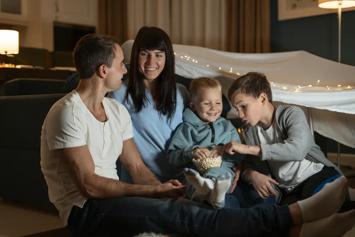 Full shot family eating popcorn