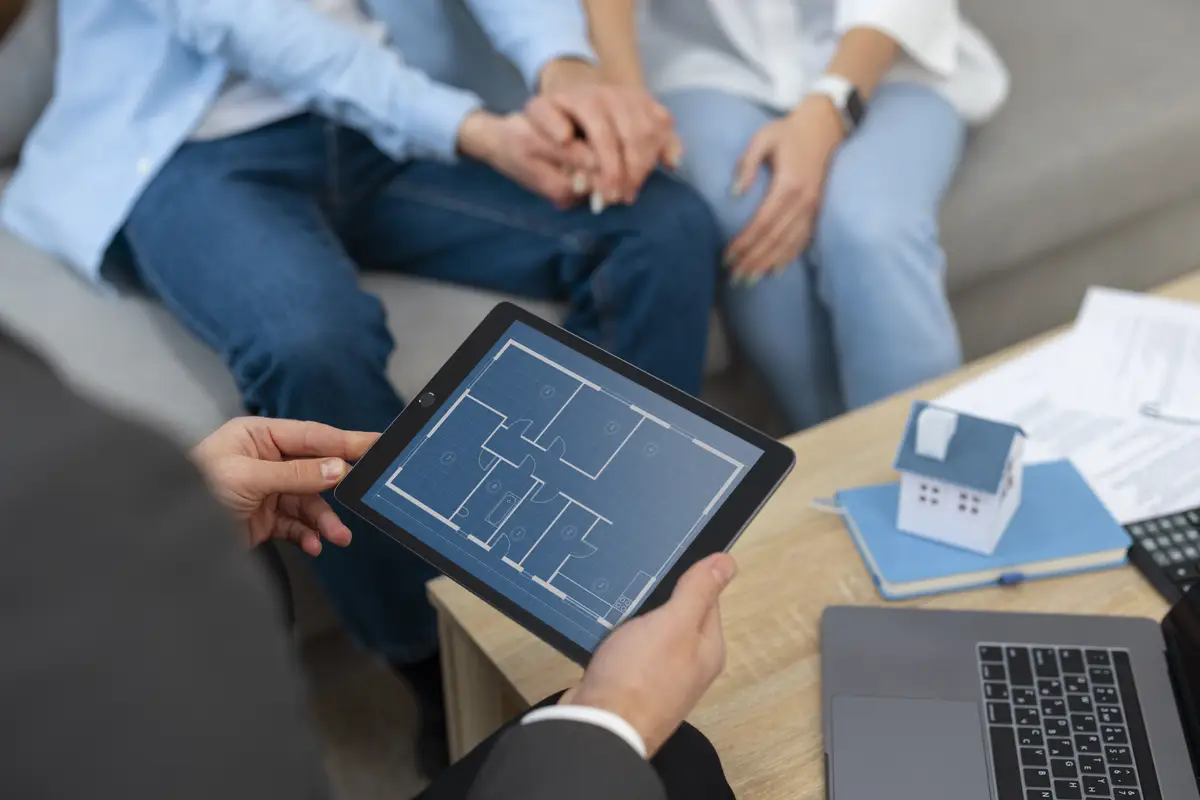 Male real estate agent doing business and showing house to potential buying couple