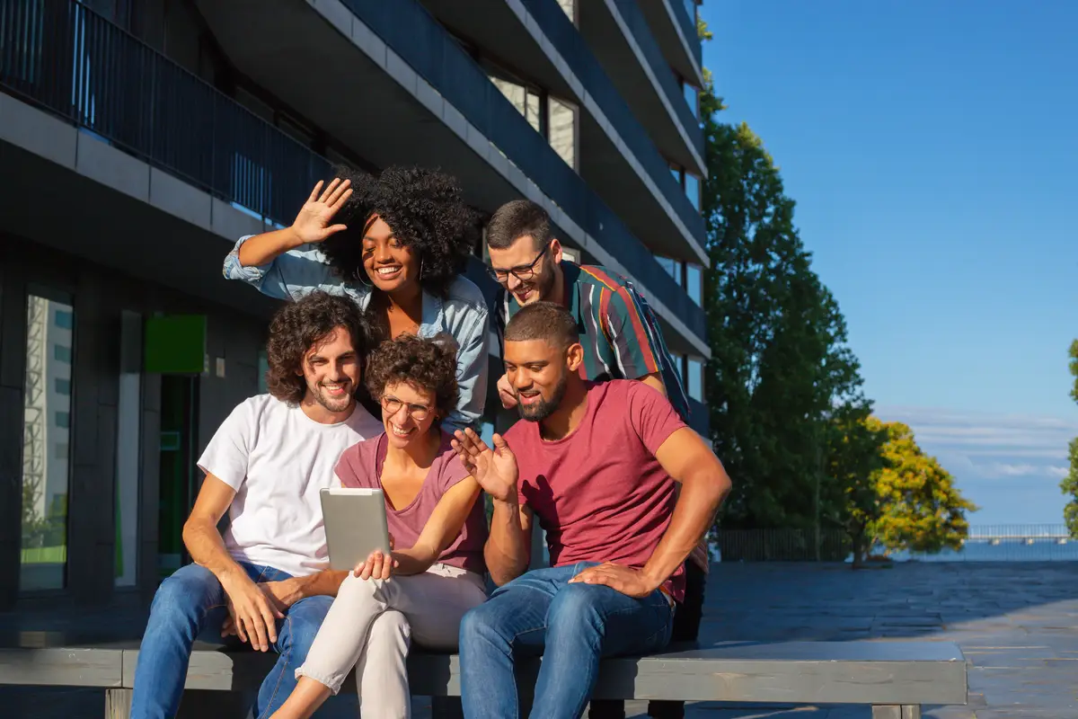 Cheerful friends using video talk app