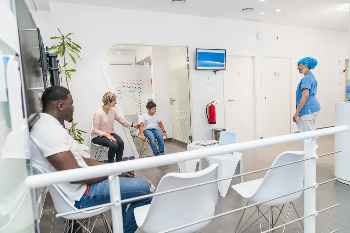 Dental hygienist interacting with patients in the waiting room of a dental clinic