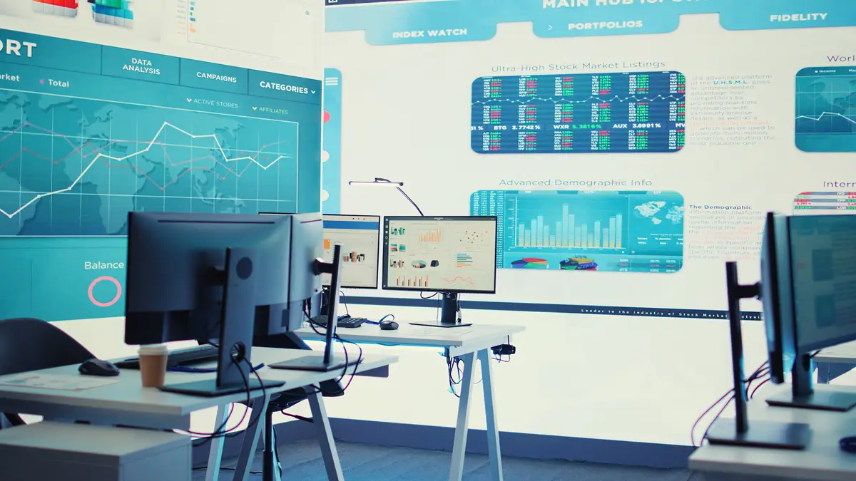 Empty boardroom space with multiple workstations having computers