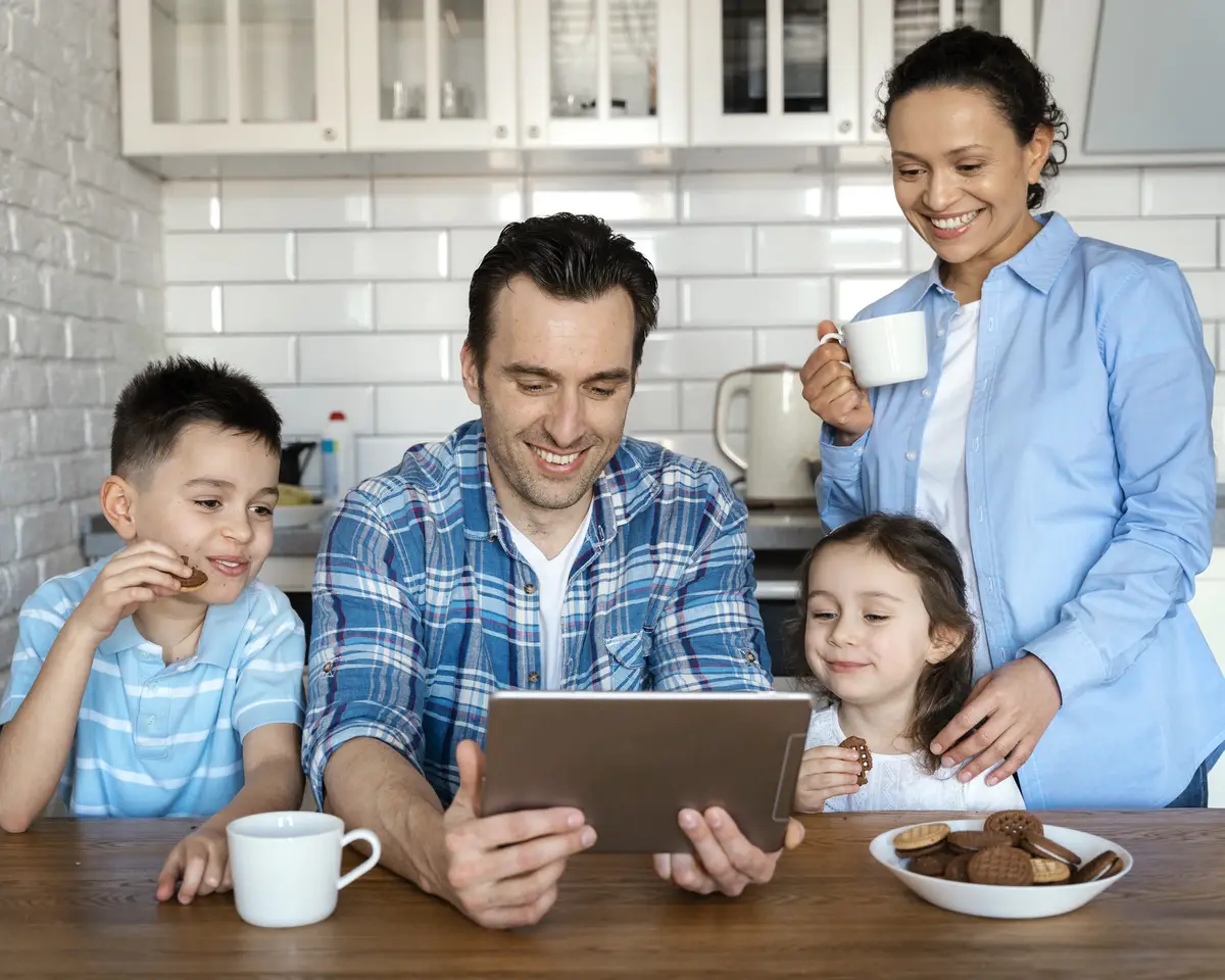 Medium shot parents and kids with tablet