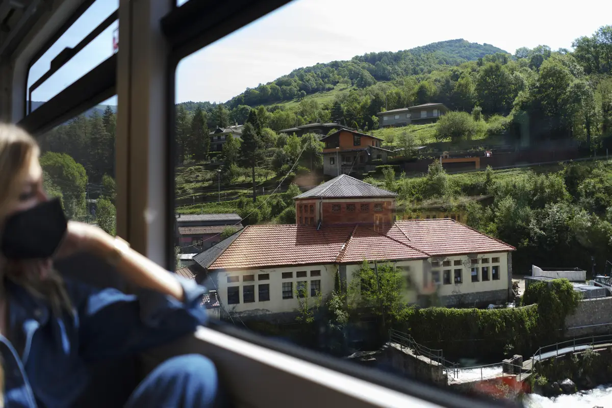 Young woman with medical mask looking at a beautiful nature view
