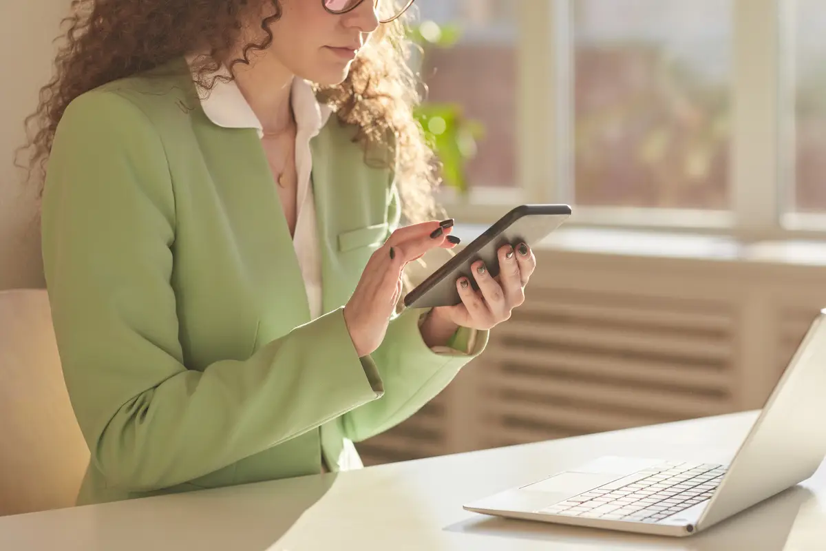 Woman Using Smartphone In Office