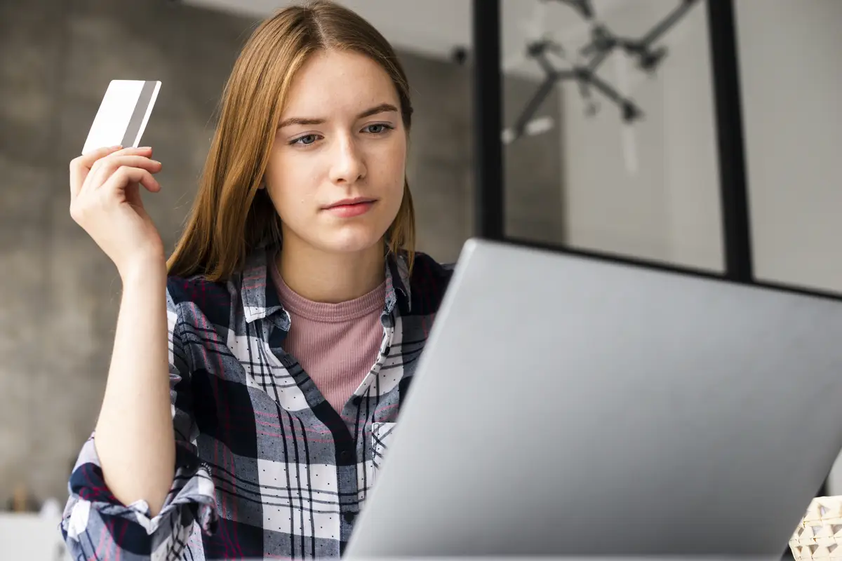 Low-angle shot of woman looking at laptop 