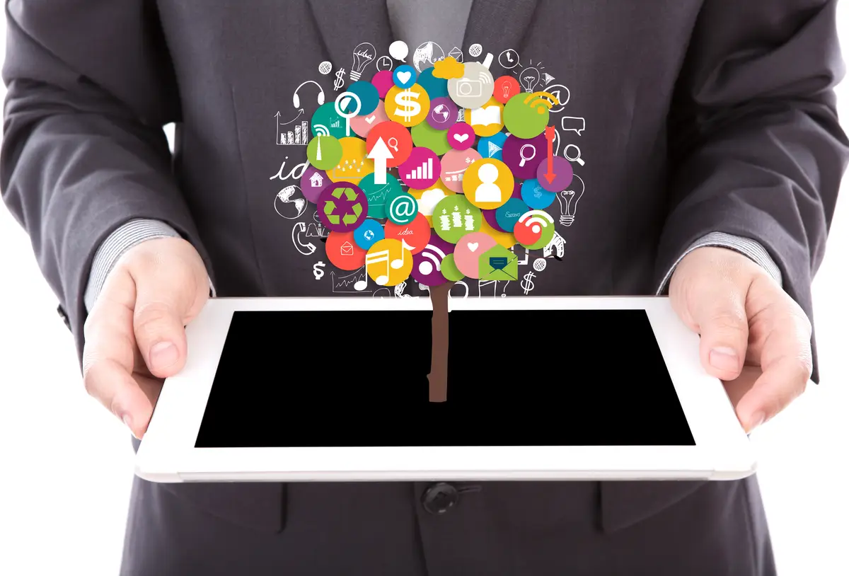 Businessman holding a tablet with colorful icons