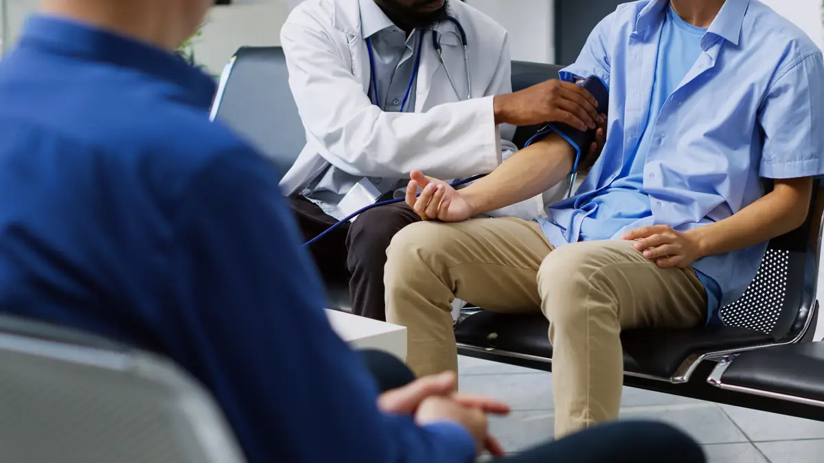 A doctor is checking a patient's blood pressure.