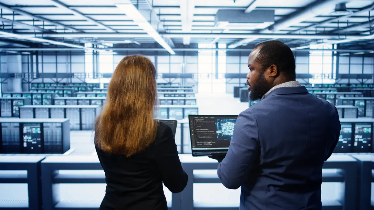 Teamworking programmers in data center overseeing server operations