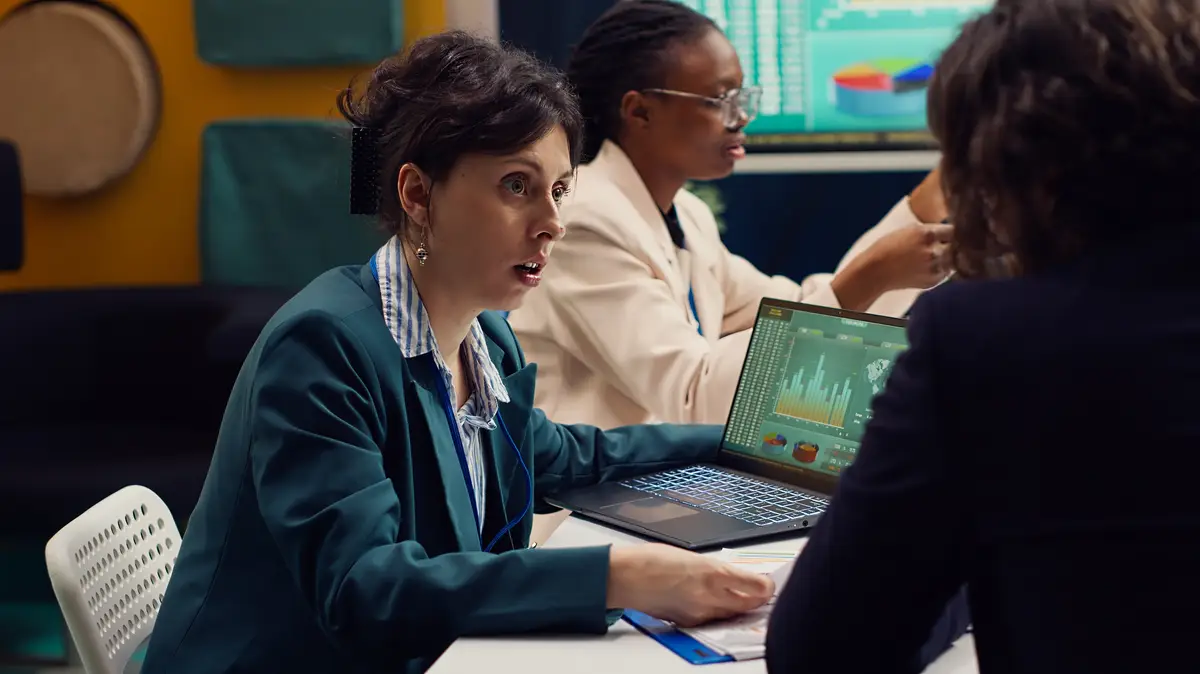 Startup team review financial reports and performance metrics on laptop