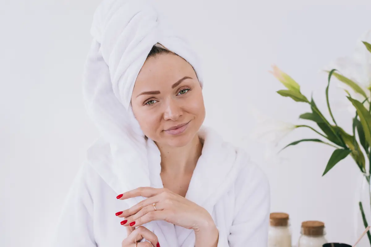 Blonde girl posing in the bathroom with bath robe