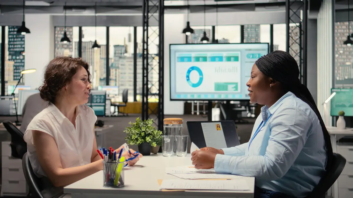 New hire sharing a handshake and receiving id security pass from hr manager in onboarding meeting