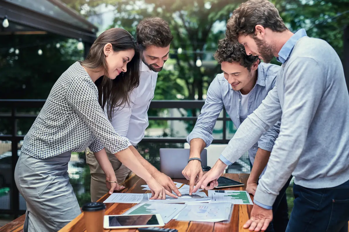 Business people paperwork and sales at cafe meeting statistics and market research for plan Staff team building and support or collaboration on project speaking and brainstorming at restaurant