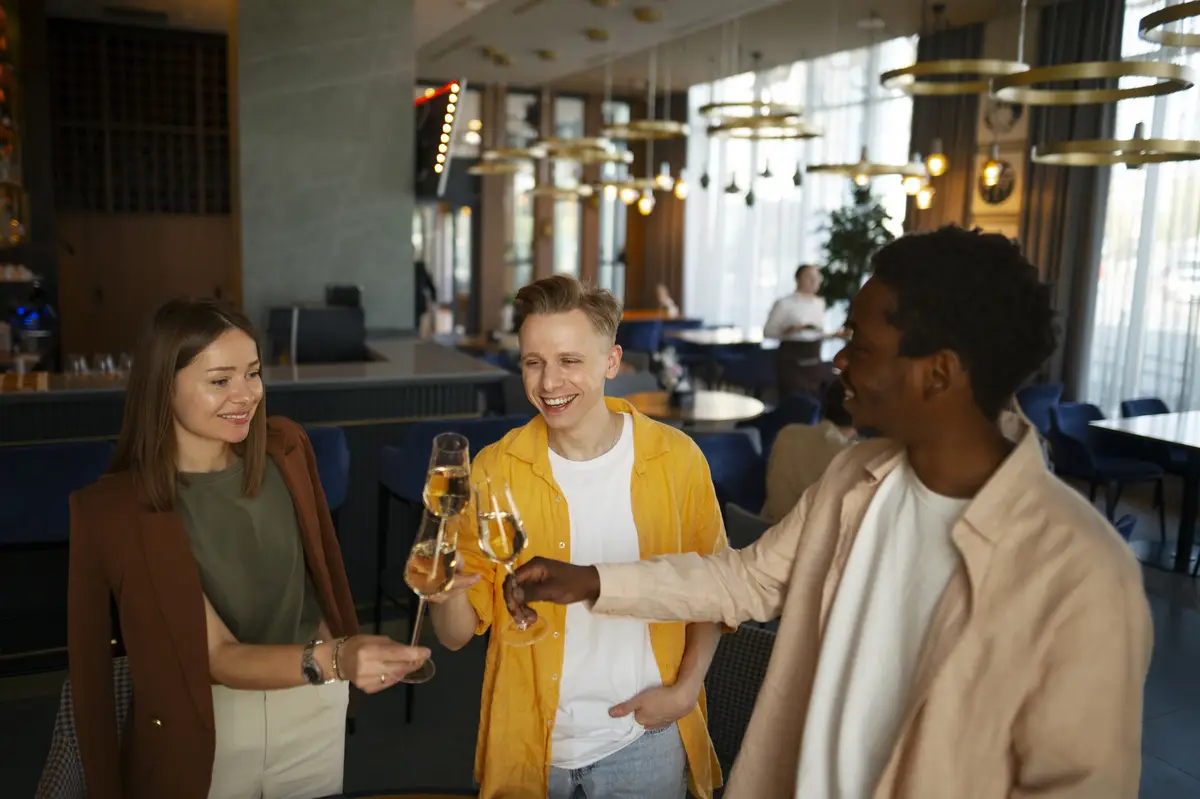 Group of friends cheering with wine glasses at a restaurant