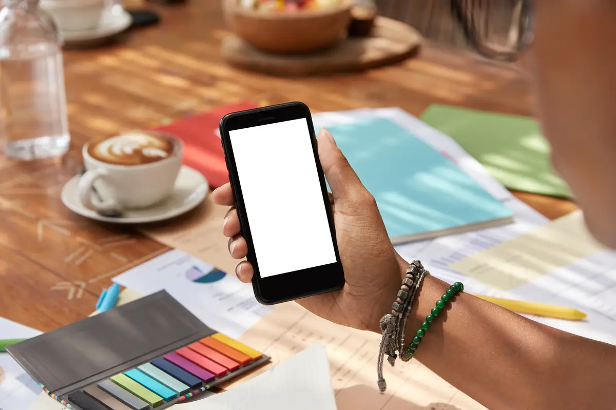 Selective focus on modern cell phone with blank white mock up screen