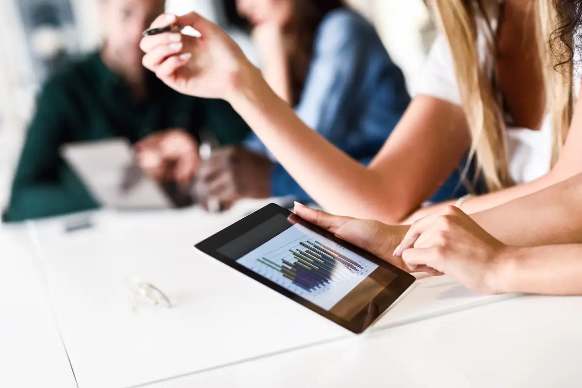 Group of young men and woman coworking with tablet computer
