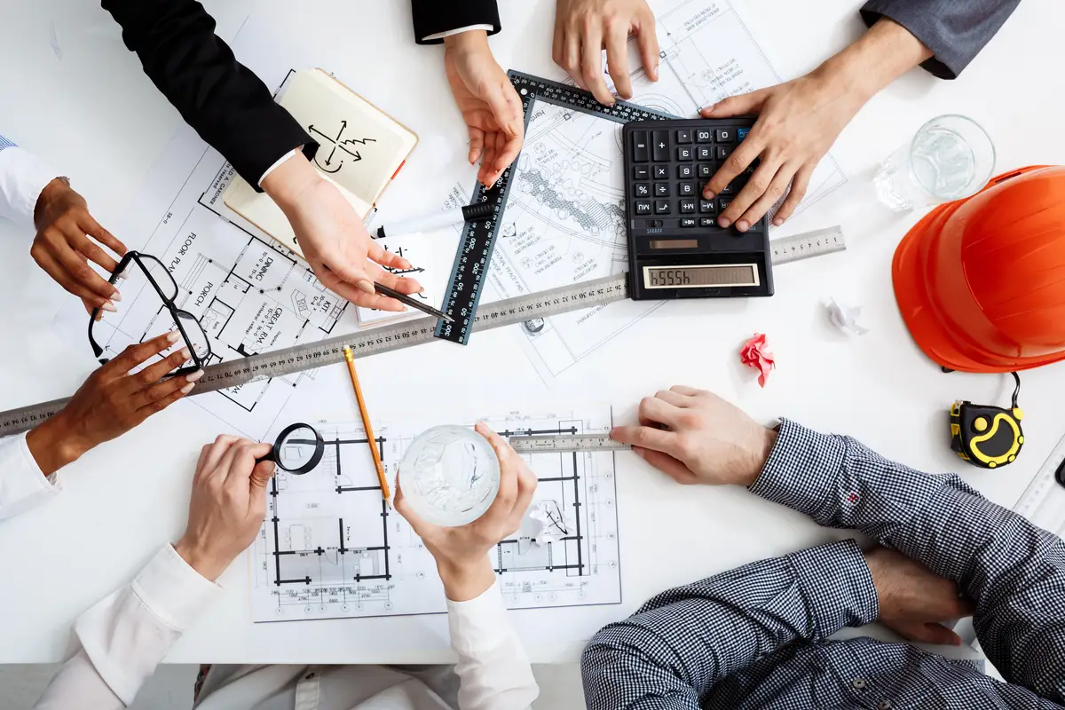  businessmen hands on white table with documents and drafts