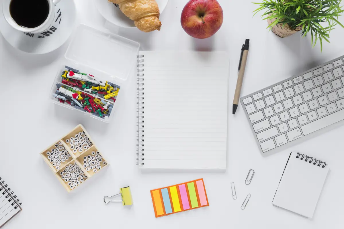 Healthy breakfast with office stationeries on white backdrop