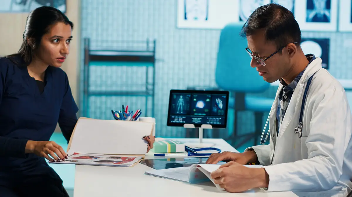 Physician meeting with a patient to discuss medical test results in a cabinet