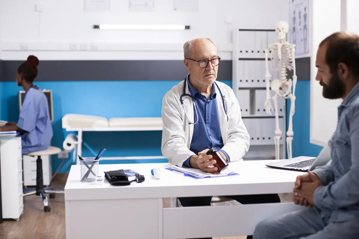 Doctor gives medication to young man