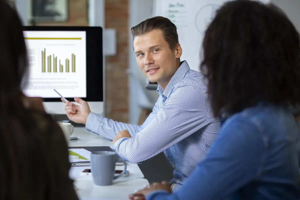 People smiling while in conference room