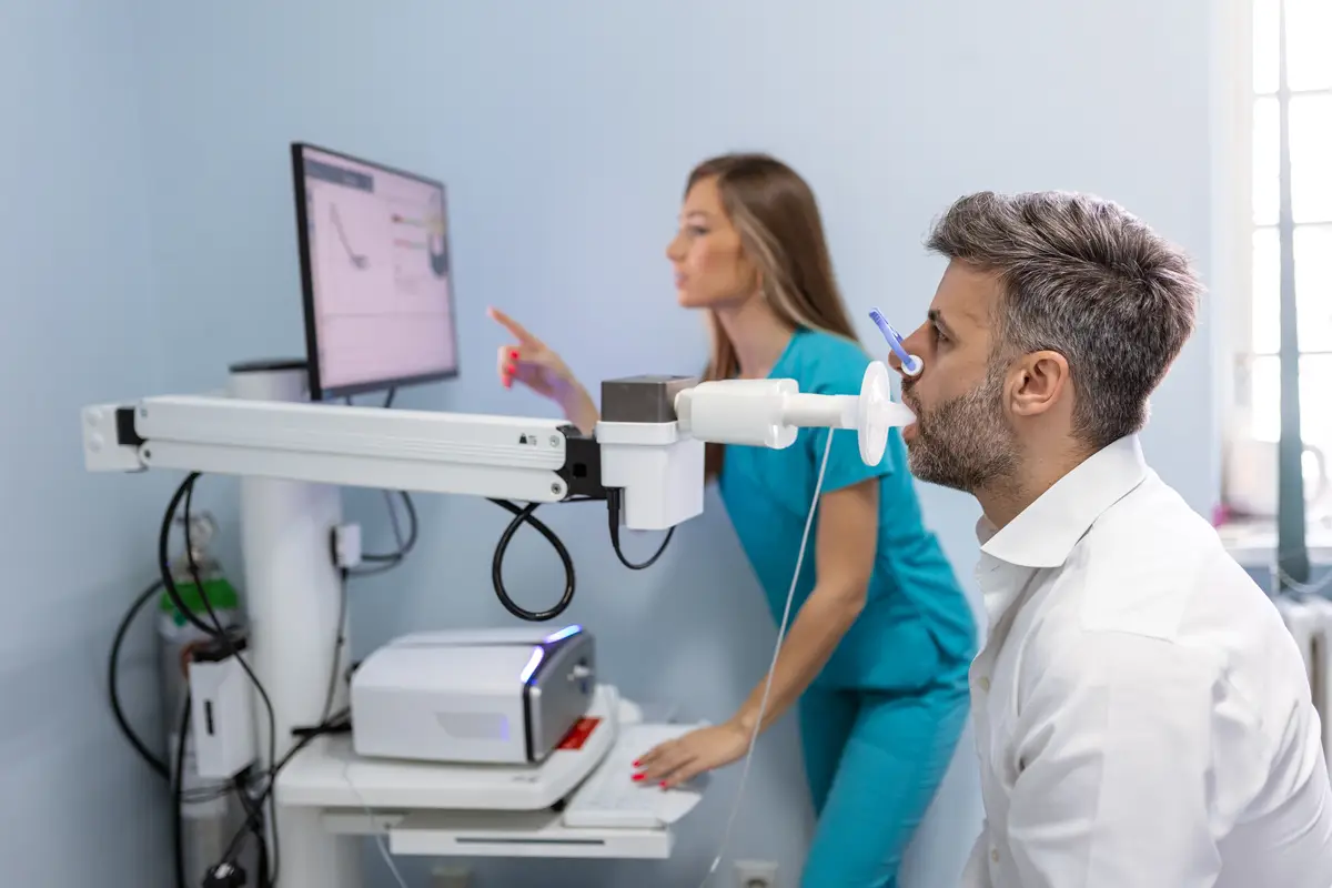 Man performing pulmonary function test and spirometry using spirometer at medical clinic Spirometry of lungs