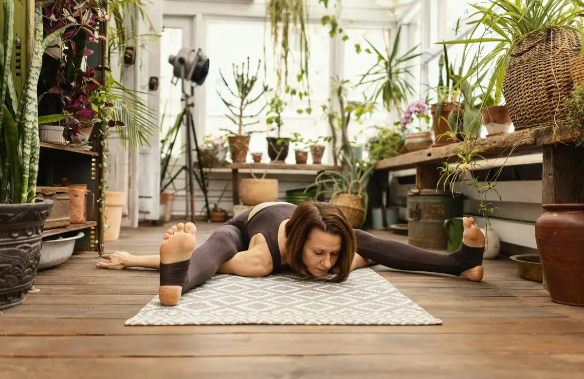 Full shot woman stretching on mat