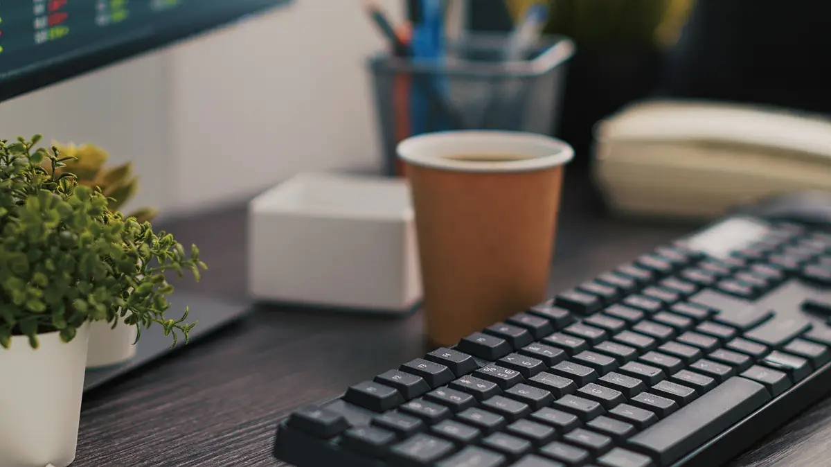 Company files and coffee on table in accounting office close up