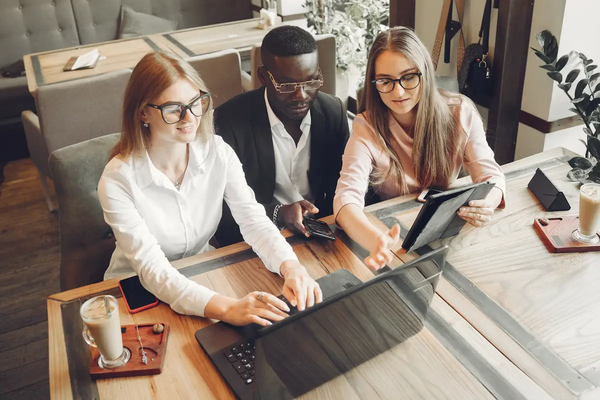 African man. Guy in a black suit. Students with a laptop. Girl in white blouse.