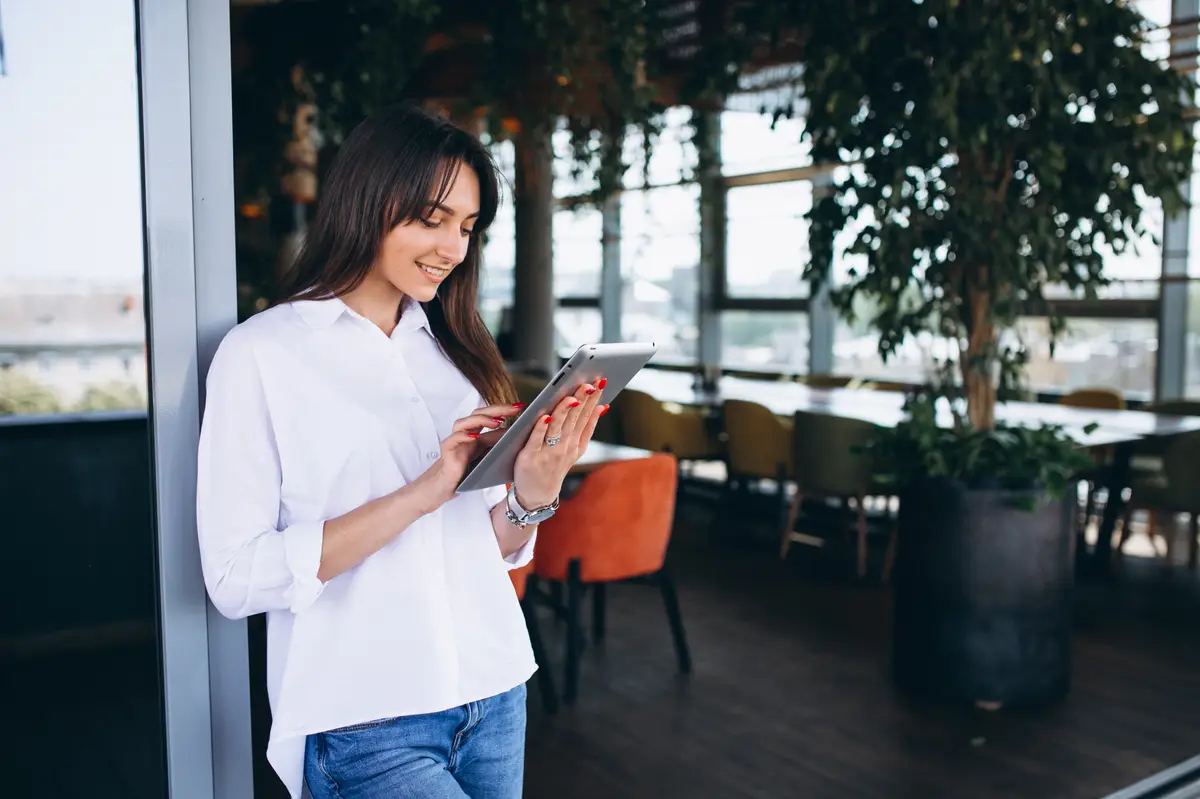Woman with tablet in a cafe