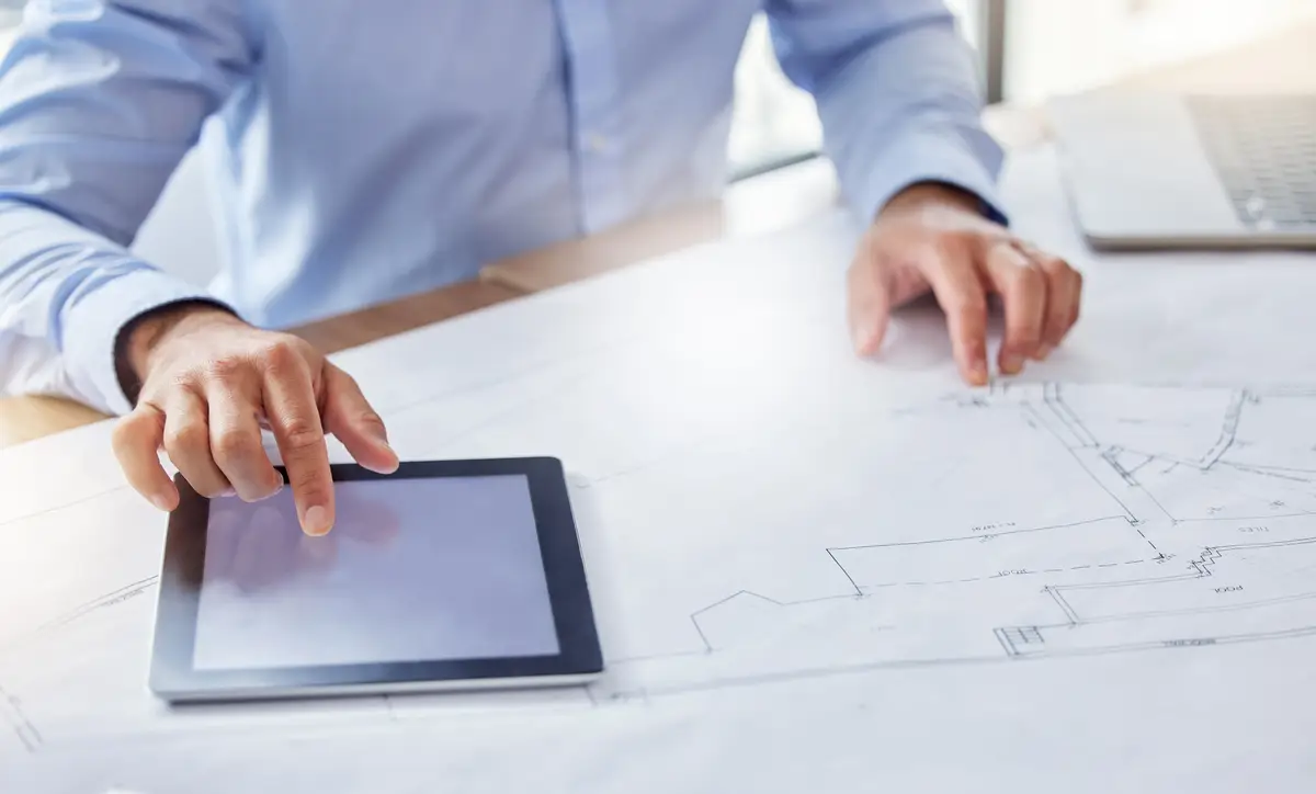 Business person architect and hands with tablet screen or blueprint for construction planning or brainstorming on desk Engineer or designer with technology document or paperwork for architecture