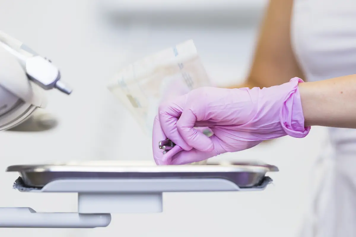 Close-up of a dentist's hand holding dental tools