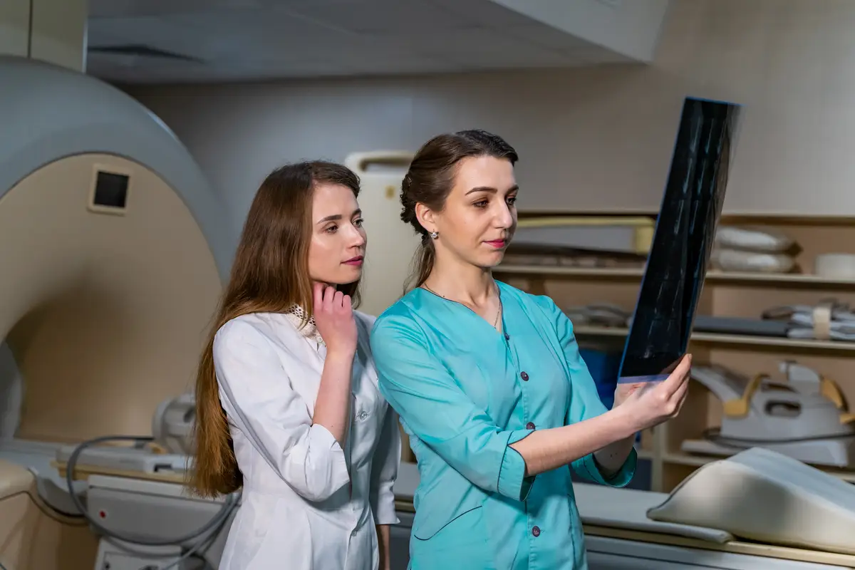 Two female women medical doctors looking at xrays in a hospital Neurosurgery concept