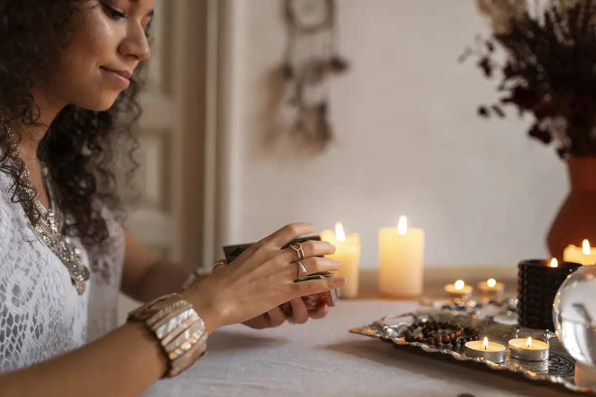 Side view woman reading tarot at home