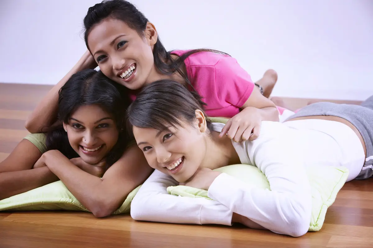 Portrait of a smiling young woman lying on floor