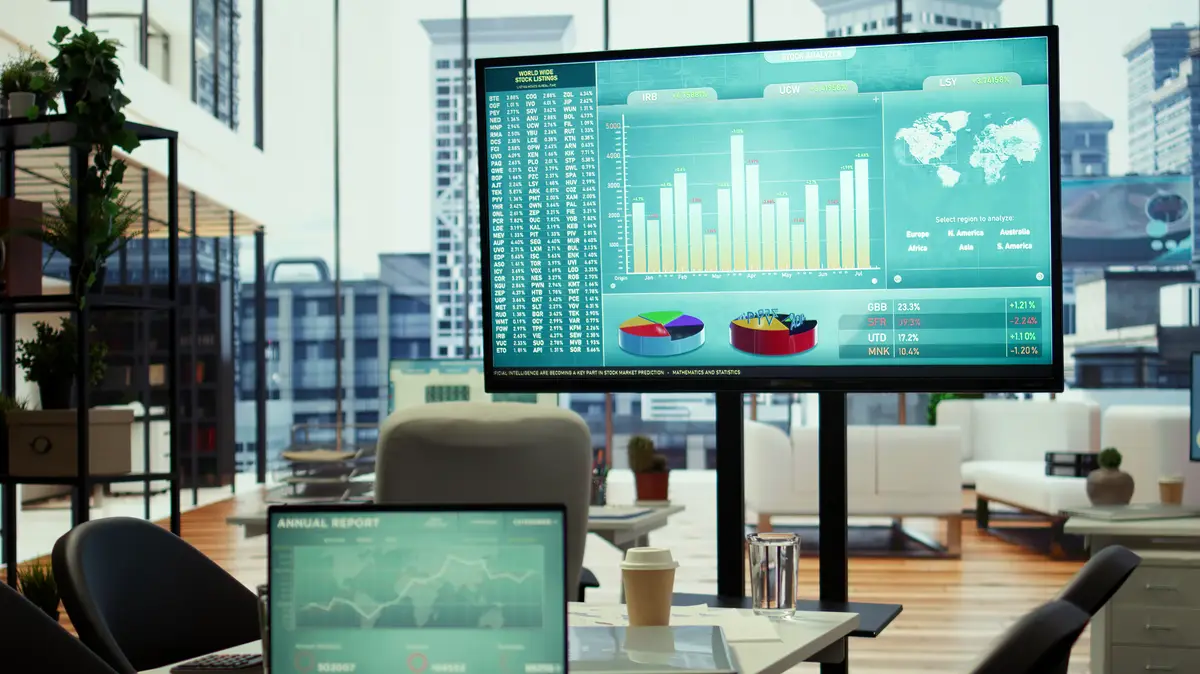 In a professional boardroom computer screen showcases business data and statistics aiding executives