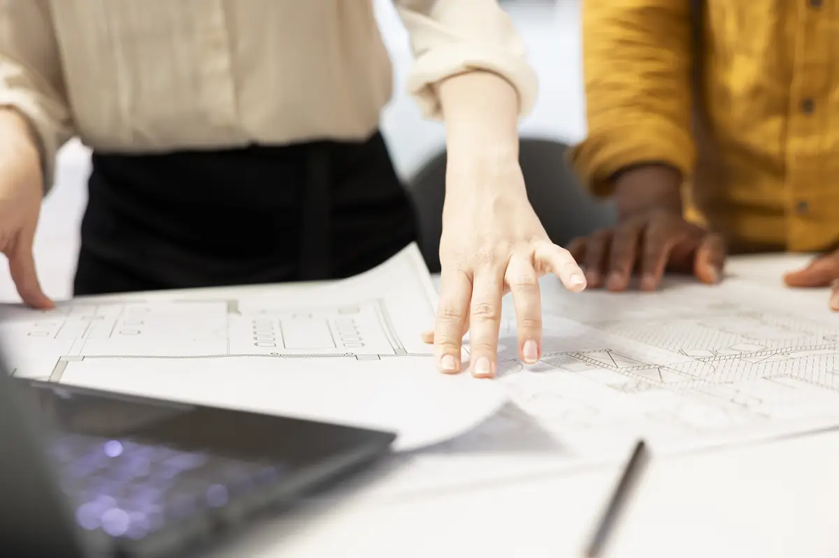Professional clients and real estate agent engage in an office planning session