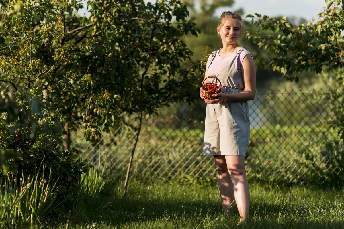Full shot woman posing with fruit basket