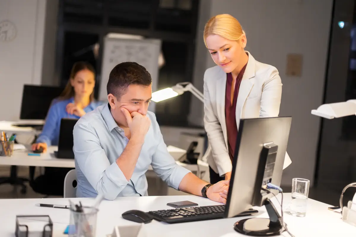 business team with computer working late at office