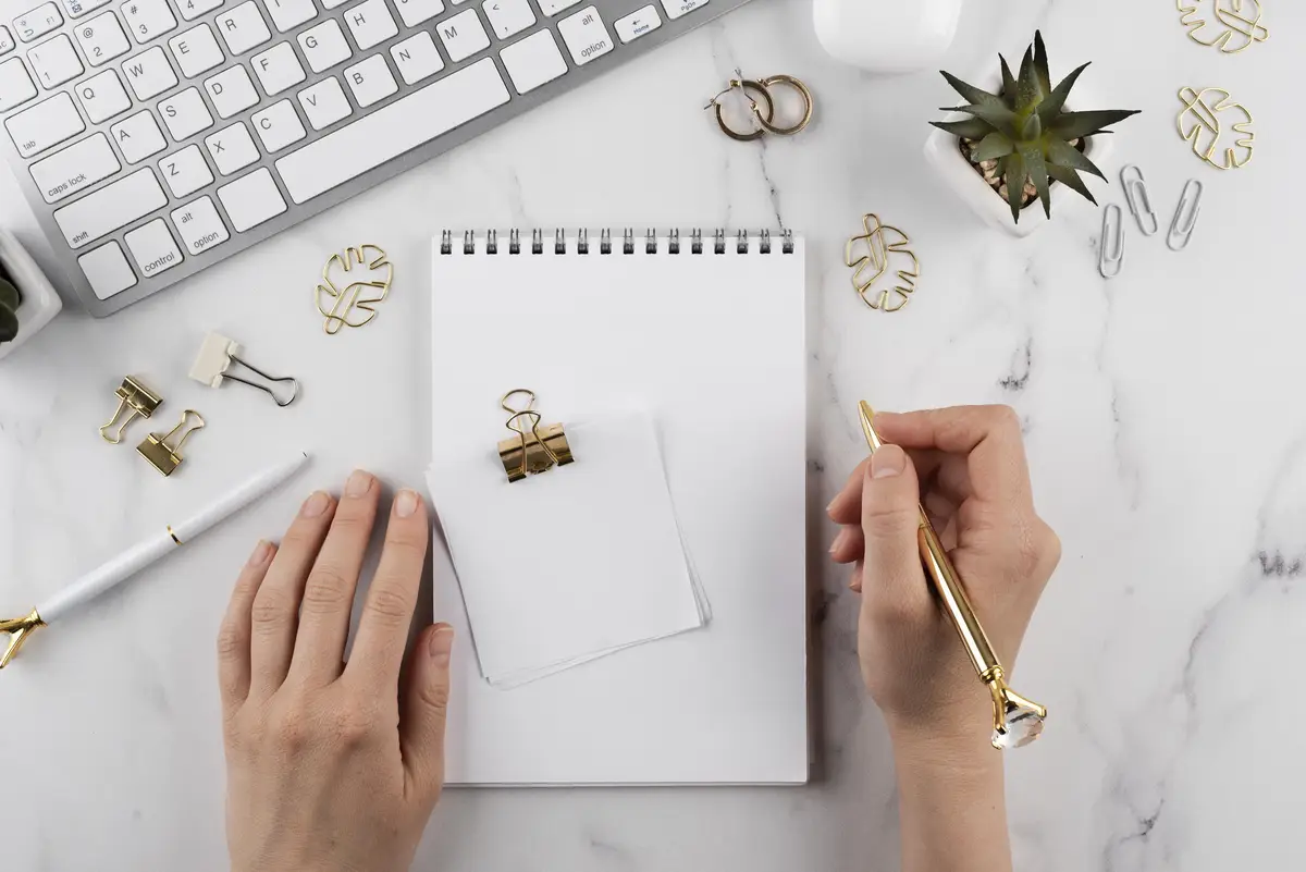 Close up hand holding golden pen