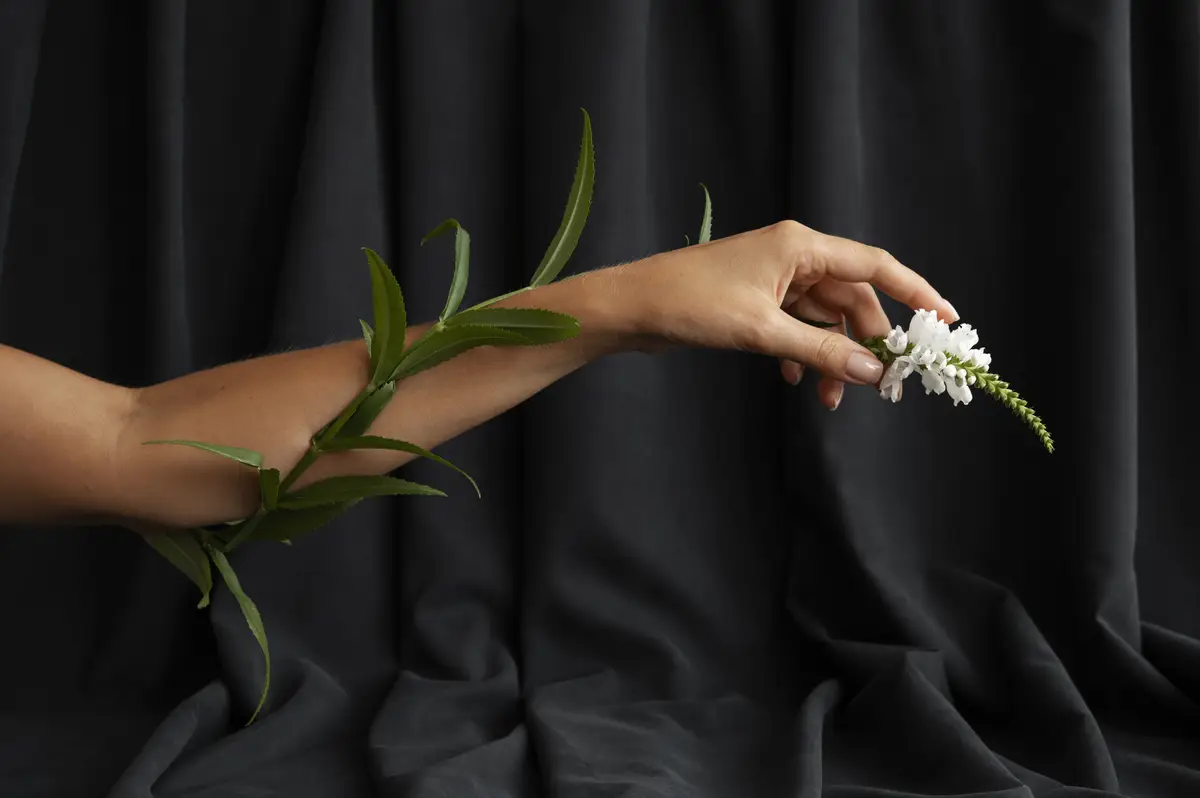 Side view hand holding flower