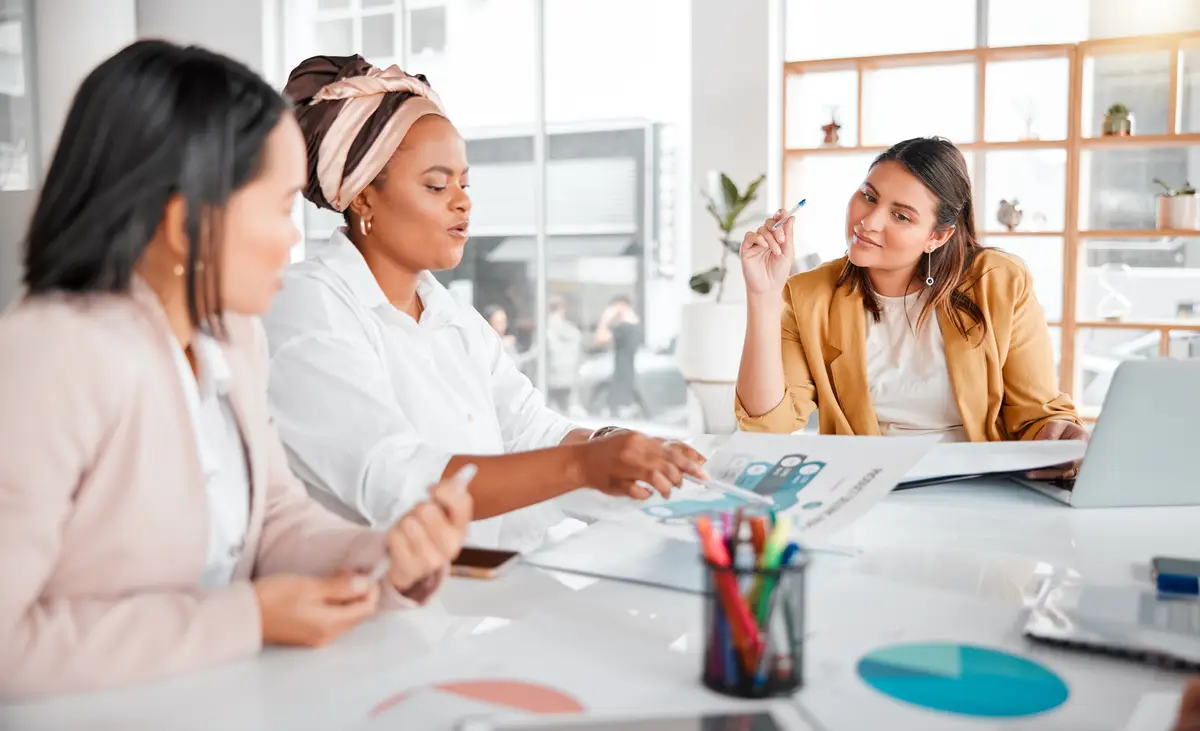 Reading charts teamwork or business people in meeting for company growth strategy review or innovation thinking in office Group of startup women for SEO schedule or planning calendar research