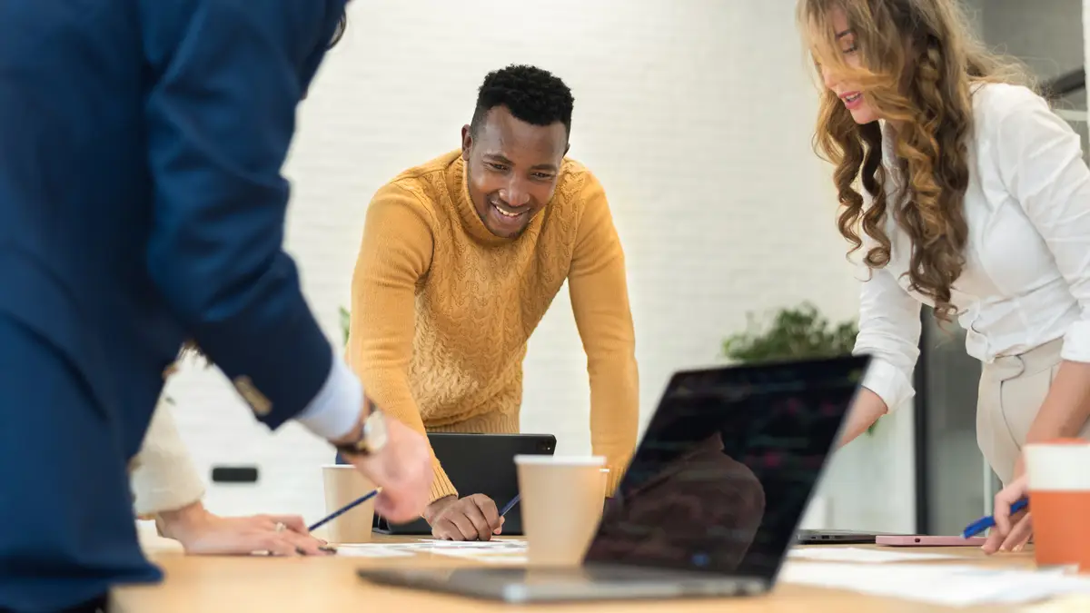 Black male team leader at business meeting in an office